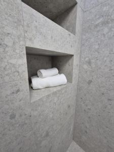 a bathroom with two rolled towels on a shelf at Vamesu Frontiers - Luxury borders in Sibiu +89 photos