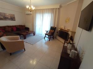 a living room with a couch and a table at SOUROTI Pinios House in Sourotí