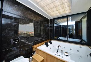 a bathroom with a bath tub and a large window at Villa Belmora Villa Asgora in Demre +29 photos