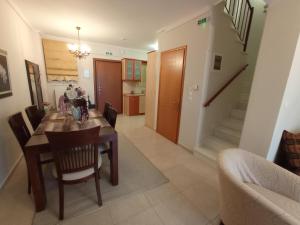 a kitchen and dining room with a table and chairs at SOUROTI Pinios House in Sourotí