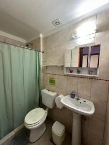 a bathroom with a toilet and a sink at Huaka Guesthouse and Hostel in Cafayate +74 photos