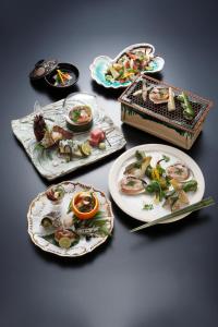 a group of plates of food on a table at Akazawa Geihinkan in Ito