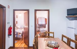 a dining room with a table and a room with a bedroom at Casa do Palheiro in Campo do Gerês