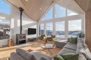a living room with a couch and a fireplace at 32 Chemin Blanc in Stoneham