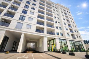 a large white building with large windows at Urban Forest Apartment - with free Garage in Podgorica