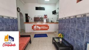 a restaurant with a counter and a table in a room at HOTEL CONSULADO Junto al Consulado de Venezuela in Cúcuta