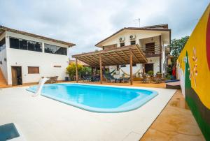 a swimming pool in the backyard of a house at Pousada das Estrelas in Itaúnas