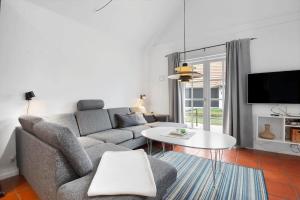 a living room with a couch and a table at BV435-Blavand-Horns-Bjerge-3-59 in Blåvand