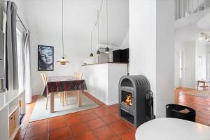 a kitchen and dining room with a stove in a room at BV435-Blavand-Horns-Bjerge-3-59 in Blåvand