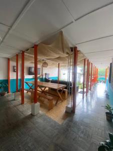 a living room with a table and a couch at Hostal Arraigo - A 1 calle del Parque Principal in Santa Rosa de Cabal