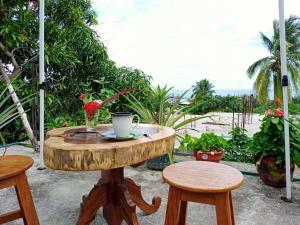 a wooden table with a coffee cup on top of it at Esperanza Casa de Huéspedes in Brisas de Zicatela