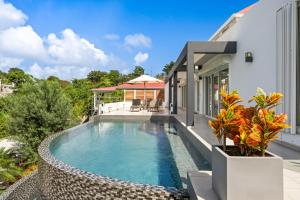 a swimming pool in the backyard of a house at Villa Angel Sunset in Gustavia