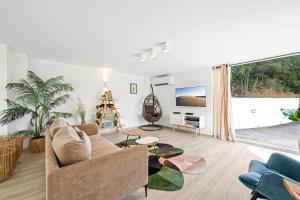 a living room with a couch and a table at Villa Angel Sunset in Gustavia