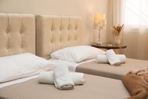a bedroom with two beds with white pillows at Luxury and Cozy Chios in Chios