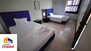 a hotel room with a bed and a bed and a tub at HOTEL CONSULADO Junto al Consulado de Venezuela in Cúcuta