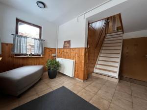 a living room with a staircase and a stair case at Ferienhaus Kluttig in Hörnitz