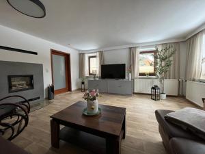 a living room with a couch and a table at Ferienhaus Kluttig in Hörnitz