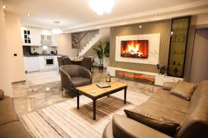a living room with a couch and a fireplace at Villa Belmora Villa Asgora in Demre