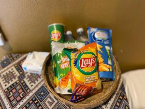 a basket filled with chips and snacks on a table at Km 0 home Du Già in Muong Cha