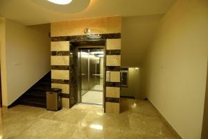 a hallway with a glass door in a building at Sky Residency in Chennai