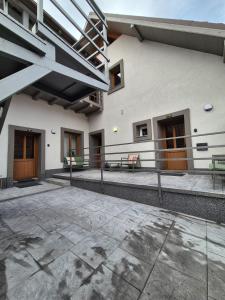 a courtyard of a building with wooden doors and benches at Vamesu Frontiers - Luxury borders in Sibiu