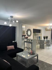 a living room with a couch and a table at Lavender Home in Volos
