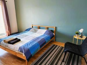 a bedroom with a bed and a chair at Hug House in Chiang Rai +26 photos
