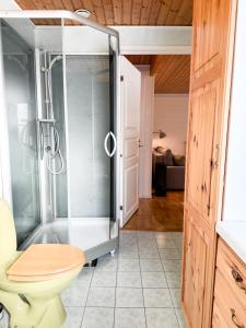 a shower with a glass door in a bathroom at Levrasjön Lake House Private Pier in Bromölla +20 photos