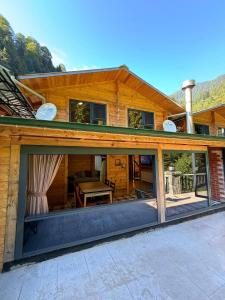 a house with large sliding glass doors on it at Ayder Gencal Villa in Ayder Yaylasi