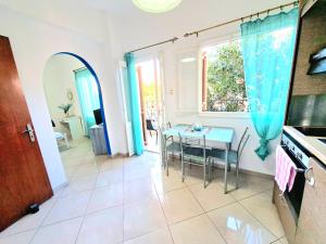 a kitchen and dining room with a table and a window at Faros studios Kalymnos Lighthouse in Kalymnos +19 photos