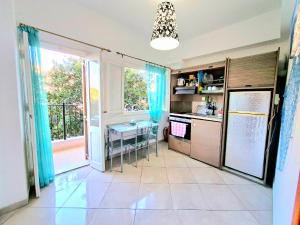 a kitchen with blue curtains and a table in it at Faros studios Kalymnos Lighthouse in Kalymnos
