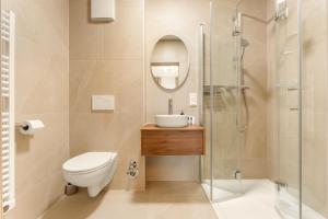 a bathroom with a toilet sink and a shower at Lake Lodge Ossiacher See in Annenheim +20 photos