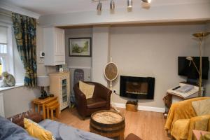 a living room with a couch and a chair and a television at No6 @ Globe Lane,Alston in Alston