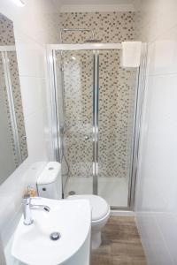 a bathroom with a shower and a toilet and a sink at Casa da Cuca in Campo do Gerês +26 photos
