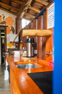 a kitchen with a sink and a coffee pot on a counter at Pousada das Estrelas in Itaúnas