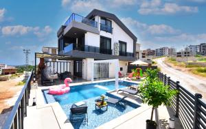 a house with a swimming pool with a pink flamingo at Villa Belmora Villa Asgora in Demre