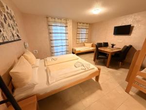 a hotel room with a bed and a dining room at Hilda Apartments Rust in Rust