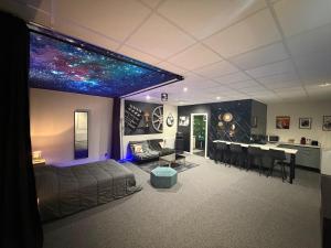 a living room with a bed and a dining room at Studio La Bobine in Coincy