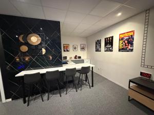 a kitchen with a counter and bar stools at Studio La Bobine in Coincy