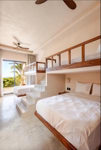 a bedroom with two bunk beds and a staircase at La Barra Resorts Luxury Villas in Paso Hondo +90 photos