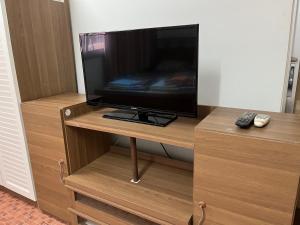 a flat screen tv sitting on top of a wooden stand at Impact Arena C9 by Jintana in Thung Si Kan
