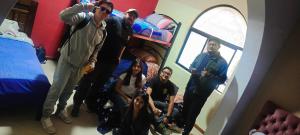 a group of people standing in a room at Hostel Del Piamonte 2 in Quito