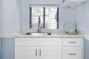 a white kitchen with a sink and a window at Sabal Palms Inn in St. Pete Beach +65 photos