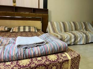 two beds and a couch in a room at Impact Arena C9 by Jintana in Thung Si Kan +56 photos