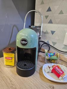 a green toaster sitting on top of a table at Cà par durmì in Gravellona Toce