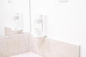 a shower with a soap dispenser in a bathroom at Hotel Equinócios Express in Barcarena +23 photos