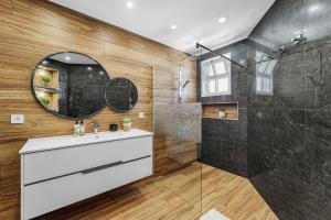 a bathroom with a sink and a shower at Cumbres Villa in Funchal +23 photos