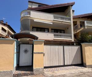 a house with a white gate and a fence at VILLA ANNAMARIA in Montesilvano