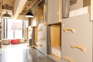 a room with white walls and a large window at Triver Coliving in Mexico City