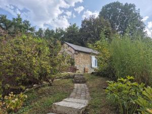 a stone house with a path leading to it at Le Moulin de serres in Bazoches